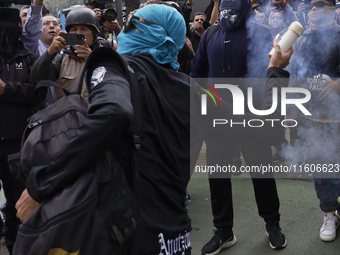 The 43 missing students from Ayotzinapa throw firecrackers at the Senate of the Republic in Mexico City, Mexico, on September 24, 2024, to d...