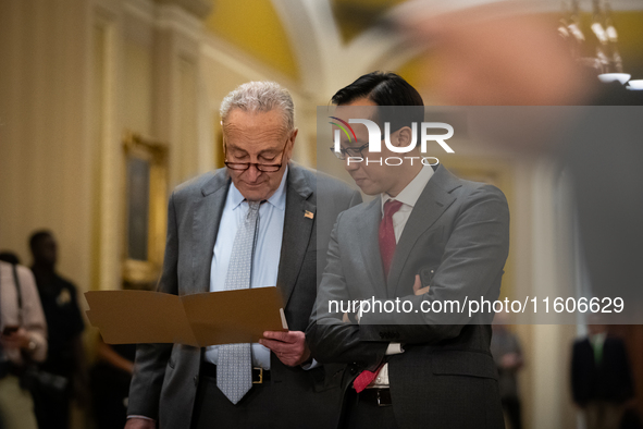 Senate Majority Leader Chuck Schumer (D-NY) confers with an aide while Senate Democrats hold their weekly press conference in  Washington, D...