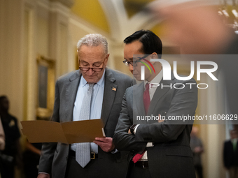 Senate Majority Leader Chuck Schumer (D-NY) confers with an aide while Senate Democrats hold their weekly press conference in  Washington, D...