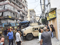 Security forces and medical teams arrive in the area after the Israeli army targets the 4th and 5th floors of a building in the Ghobeiry mun...