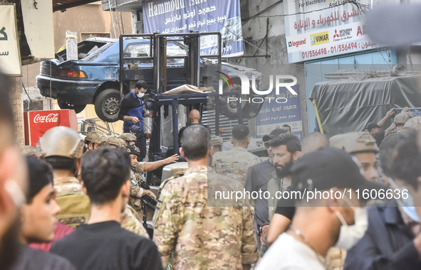 Security forces and medical teams arrive in the area after the Israeli army targets the 4th and 5th floors of a building in the Ghobeiry mun...