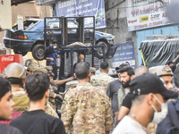 Security forces and medical teams arrive in the area after the Israeli army targets the 4th and 5th floors of a building in the Ghobeiry mun...