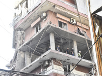 Security forces and medical teams arrive in the area after the Israeli army targets the 4th and 5th floors of a building in the Ghobeiry mun...