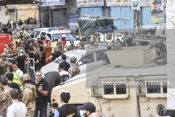 Security forces and medical teams arrive in the area after the Israeli army targets the 4th and 5th floors of a building in the Ghobeiry mun...