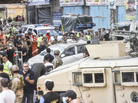 Security forces and medical teams arrive in the area after the Israeli army targets the 4th and 5th floors of a building in the Ghobeiry mun...