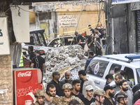 Security forces and medical teams arrive in the area after the Israeli army targets the 4th and 5th floors of a building in the Ghobeiry mun...