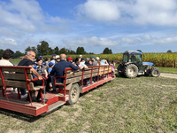 People take a tractor wagon ride to an apple orchard in Stouffville, Ontario, Canada, on September 22, 2024. (