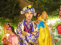 A stilt performer prepares to perform for tourists at the ancient town of Xunxian in Hebi, China, on September 24, 2024. (