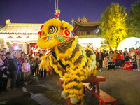 Actors perform a lion dance for tourists at the ancient town of Xunxian in Hebi, China, on September 24, 2024. (