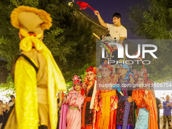 Stilt performers perform for tourists at the ancient town of Xunxian County in Hebi, China, on September 24, 2024. (