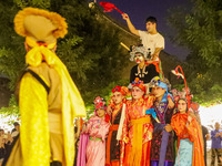 Stilt performers perform for tourists at the ancient town of Xunxian County in Hebi, China, on September 24, 2024. (