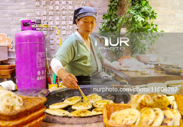 A stall in the ancient town of Xunxian County prepares local snacks for tourists in Hebi, China, on September 24, 2024. 