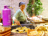 A stall in the ancient town of Xunxian County prepares local snacks for tourists in Hebi, China, on September 24, 2024. (