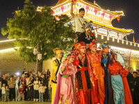 Stilt performers perform for tourists at the ancient town of Xunxian County in Hebi, China, on September 24, 2024. (