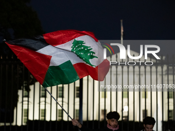 People fly a half Palestinian and half Lebanese flag during a pro-Lebanon demonstration in front of the White House following extensive air...