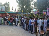 Voters queue to cast their ballots at a polling station during the second phase of assembly elections in Srinagar, Jammu and Kashmir, on Sep...