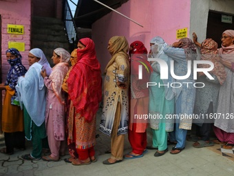 Women voters queue to cast their ballots at a polling station during the second phase of assembly elections in Srinagar, Jammu and Kashmir,...