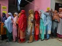 Women voters queue to cast their ballots at a polling station during the second phase of assembly elections in Srinagar, Jammu and Kashmir,...