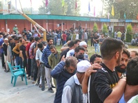 Voters queue to cast their ballots at a polling station during the second phase of assembly elections in Srinagar, Jammu and Kashmir, on Sep...