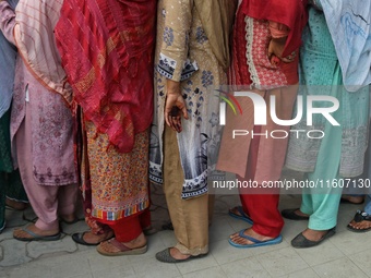 Women voters queue to cast their ballots at a polling station during the second phase of assembly elections in Srinagar, Jammu and Kashmir,...