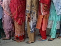 Women voters queue to cast their ballots at a polling station during the second phase of assembly elections in Srinagar, Jammu and Kashmir,...