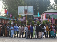 Voters queue to cast their ballots at a polling station during the second phase of assembly elections in Srinagar, Jammu and Kashmir, on Sep...