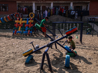 Kids play as people wait to cast their votes in the second phase of Assembly elections in Beerwah, Jammu and Kashmir, India, on September 25...