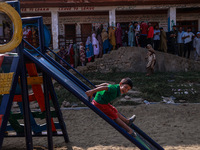 Kids play as people wait to cast their votes in the second phase of Assembly elections in Beerwah, Jammu and Kashmir, India, on September 25...