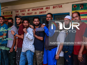 People wait to cast their votes in the second phase of Assembly elections in Beerwah, Jammu and Kashmir, India, on September 25, 2024 (