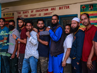 People wait to cast their votes in the second phase of Assembly elections in Beerwah, Jammu and Kashmir, India, on September 25, 2024 (