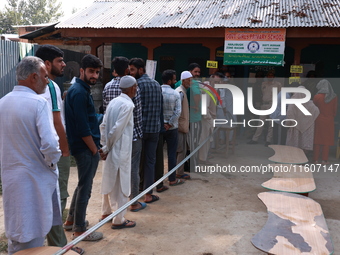 People wait to cast their votes in the second phase of Assembly elections in Beerwah, Jammu and Kashmir, India, on September 25, 2024 (