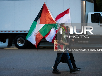 Protesters walk to a demonstration in front of the White House in support of Lebanon following extensive air strikes by Israel, in Washingto...