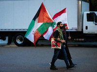 Protesters walk to a demonstration in front of the White House in support of Lebanon following extensive air strikes by Israel, in Washingto...