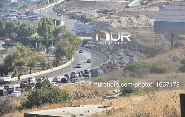 Lebanese people forced to flee their homes due to Israeli airstrikes migrate with what they can take with them to Saida, Lebanon, on Septemb...