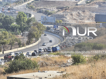 Lebanese people forced to flee their homes due to Israeli airstrikes migrate with what they can take with them to Saida, Lebanon, on Septemb...