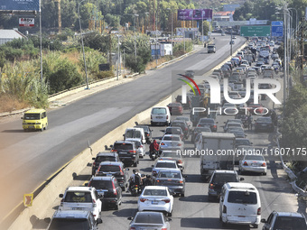 Lebanese people forced to flee their homes due to Israeli airstrikes migrate with what they can take with them to Saida, Lebanon, on Septemb...