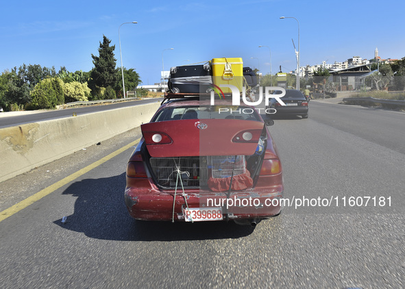 Lebanese people forced to flee their homes due to Israeli airstrikes migrate with what they can take with them to Saida, Lebanon, on Septemb...