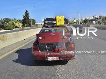 Lebanese people forced to flee their homes due to Israeli airstrikes migrate with what they can take with them to Saida, Lebanon, on Septemb...