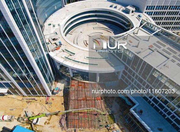 Workers step up construction at the project construction site of Big Data Industrial Park in Yuexi County, Anqing, China, on September 25, 2...