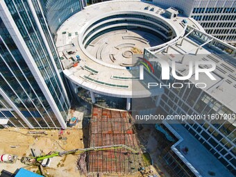 Workers step up construction at the project construction site of Big Data Industrial Park in Yuexi County, Anqing, China, on September 25, 2...