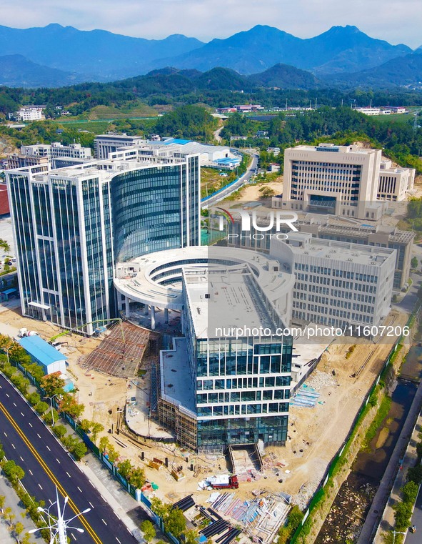 Workers step up construction at the project construction site of Big Data Industrial Park in Yuexi County, Anqing, China, on September 25, 2...