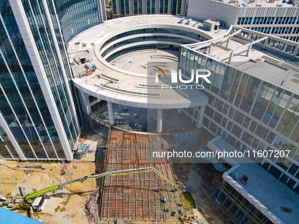 Workers step up construction at the project construction site of Big Data Industrial Park in Yuexi County, Anqing, China, on September 25, 2...