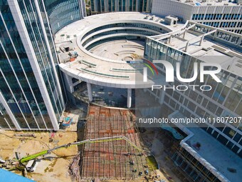 Workers step up construction at the project construction site of Big Data Industrial Park in Yuexi County, Anqing, China, on September 25, 2...