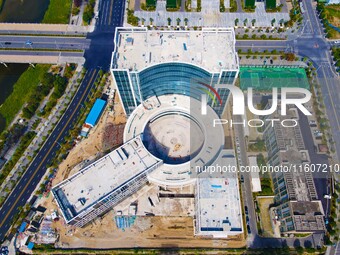 Workers step up construction at the project construction site of Big Data Industrial Park in Yuexi County, Anqing, China, on September 25, 2...