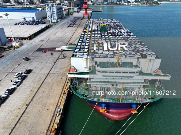 Roll-on wheels load export vehicles at the terminal of the Oriental Port Branch of Lianyungang Port in Lianyungang, China, on September 25,...