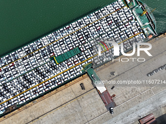 Roll-on wheels load export vehicles at the terminal of the Oriental Port Branch of Lianyungang Port in Lianyungang, China, on September 25,...