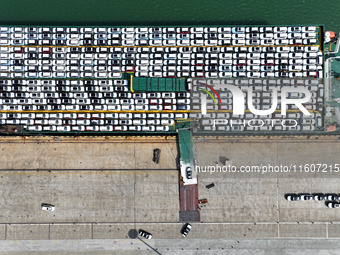 Roll-on wheels load export vehicles at the terminal of the Oriental Port Branch of Lianyungang Port in Lianyungang, China, on September 25,...