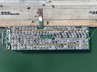 Roll-on wheels load export vehicles at the terminal of the Oriental Port Branch of Lianyungang Port in Lianyungang, China, on September 25,...