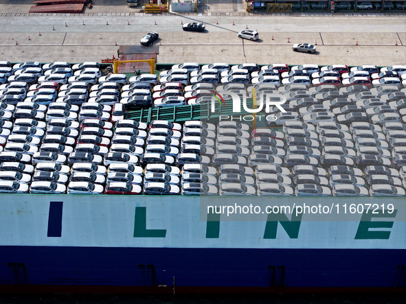 Roll-on wheels load export vehicles at the terminal of the Oriental Port Branch of Lianyungang Port in Lianyungang, China, on September 25,...