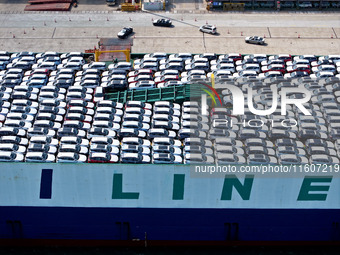 Roll-on wheels load export vehicles at the terminal of the Oriental Port Branch of Lianyungang Port in Lianyungang, China, on September 25,...